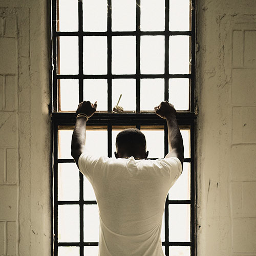 inmate standing at a window