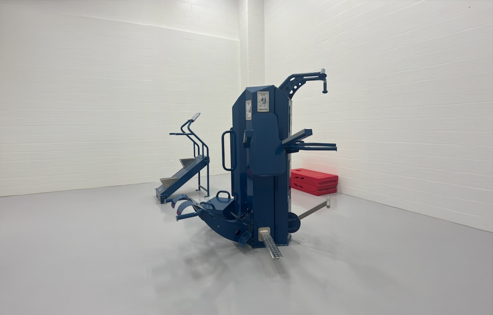 Tamperproof fitness equipment inside a correctional facility gym.