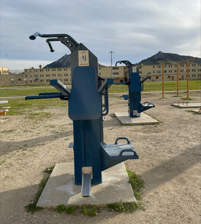 Prison recreation space outfitted with weatherproof correctional fitness systems.